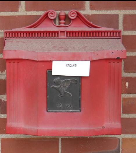 A red and white sign on a brick building

Description automatically generated