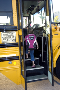 A yellow school bus parked in a parking lot

Description automatically generated