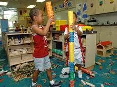 A picture containing indoor, floor, person, young

Description automatically generated