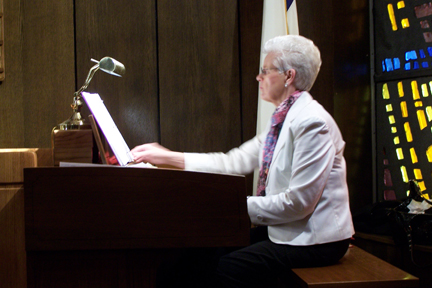 A person standing in front of a piano

Description automatically generated